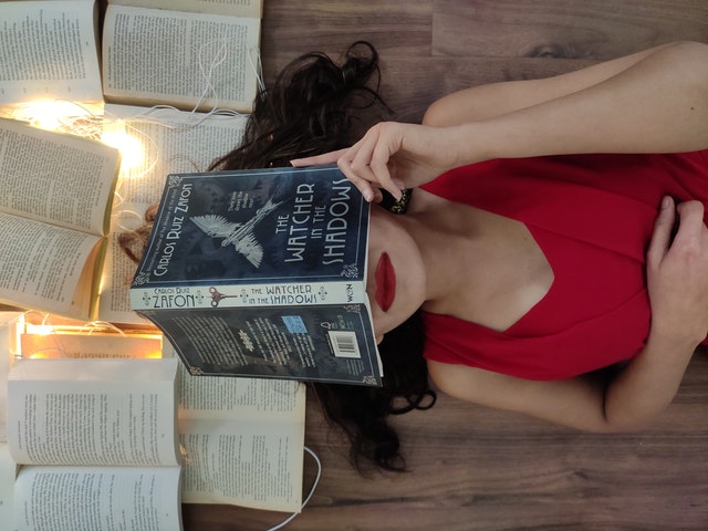 women cover her face by a book